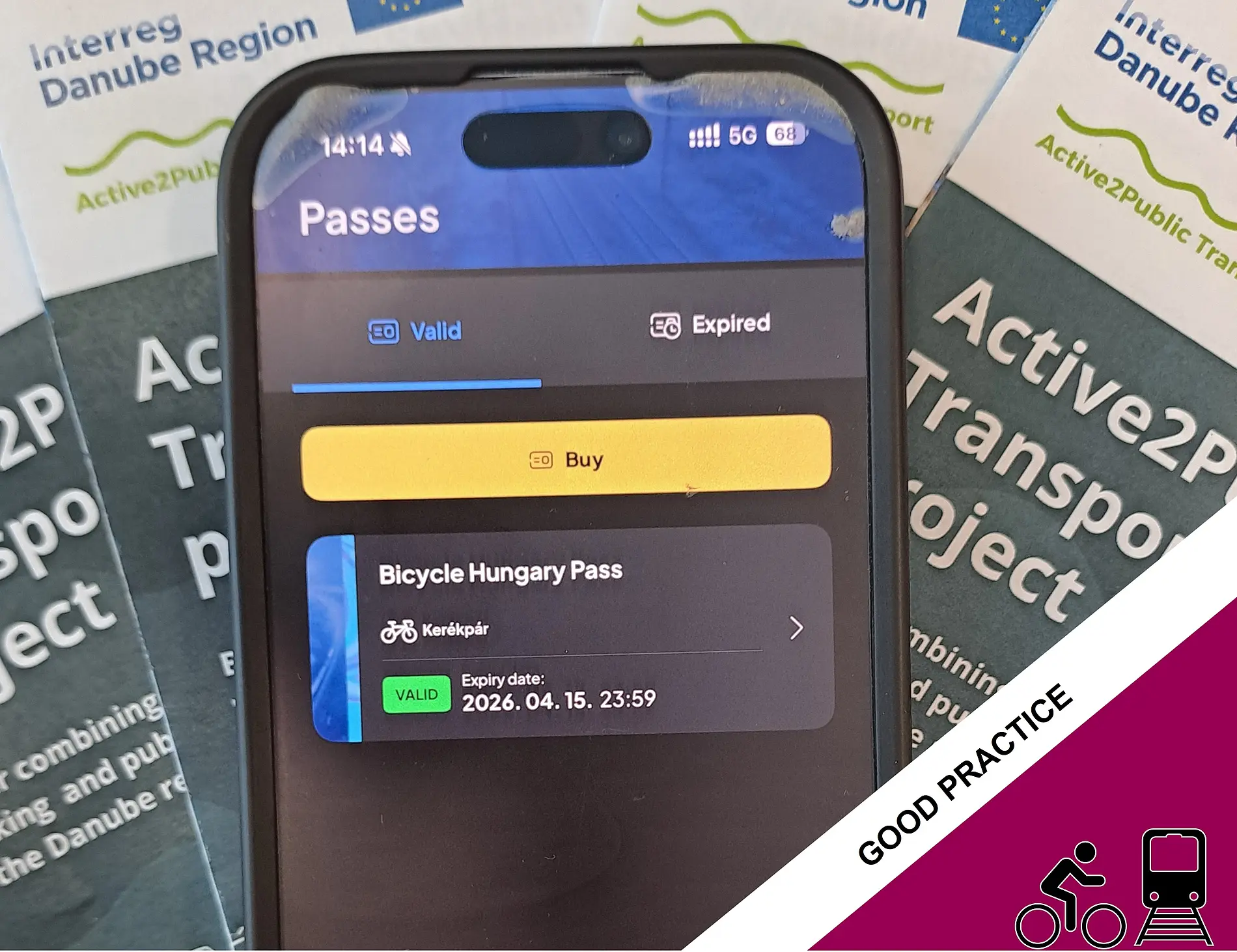 Smartphone showing Bicycle Hungary Pass, A2PT flyers in the background  