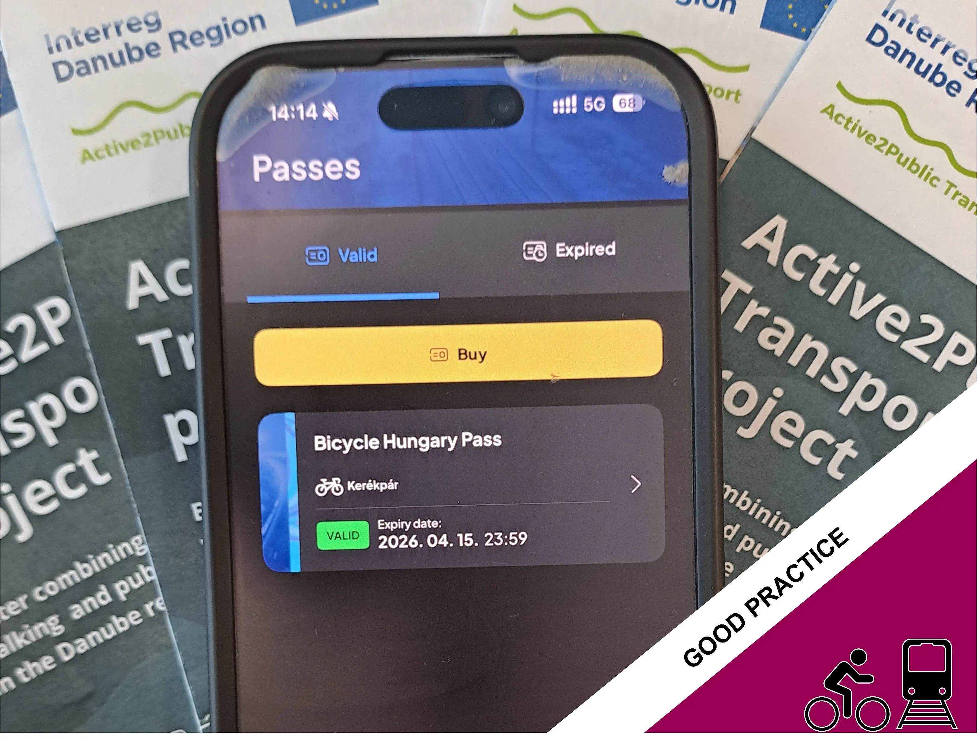 Smartphone showing Bicycle Hungary Pass, A2PT flyers in the background  
